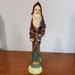 Wise old man figure holding a toy and lantern